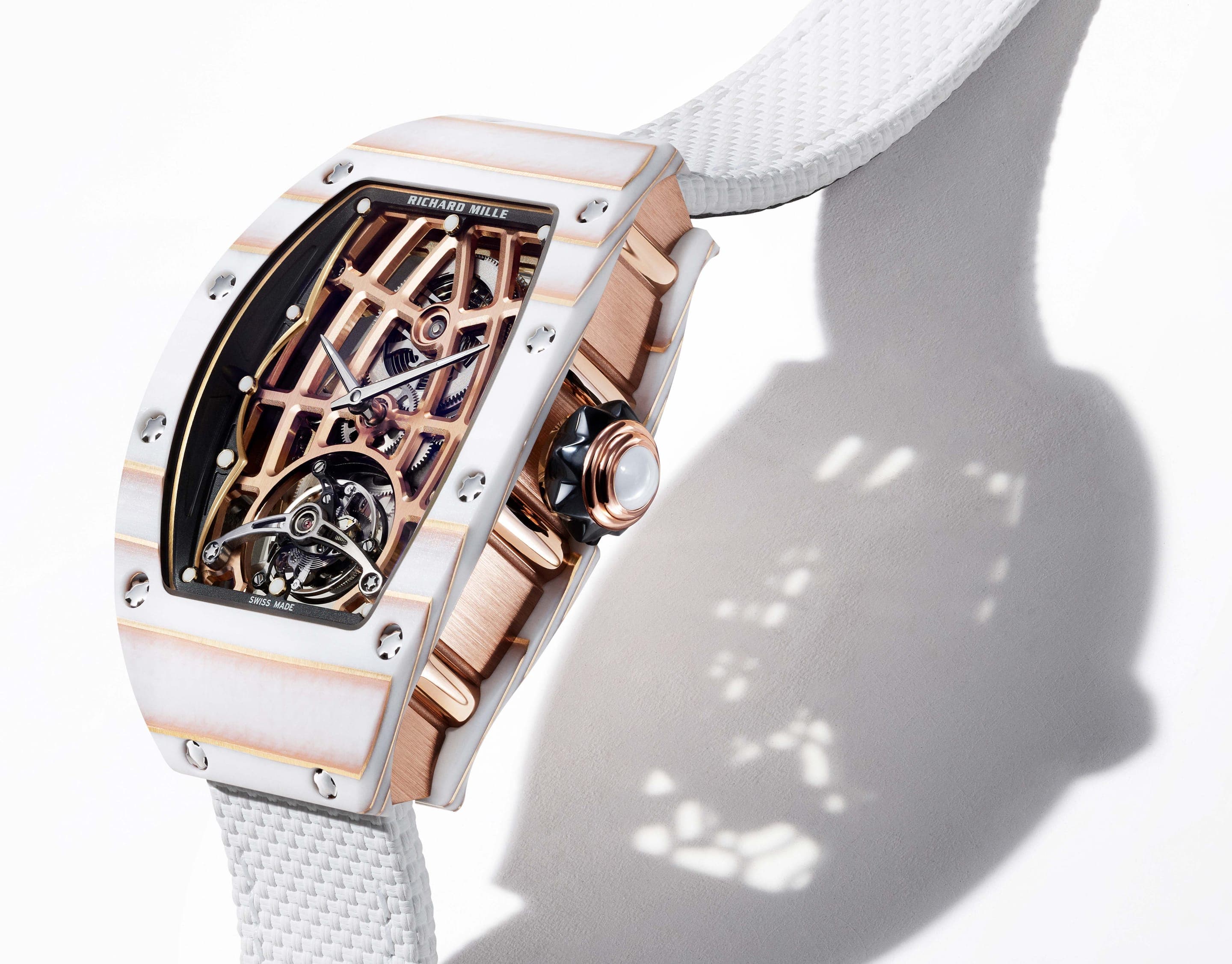 A luxury skeleton tourbillon wristwatch on a white strap